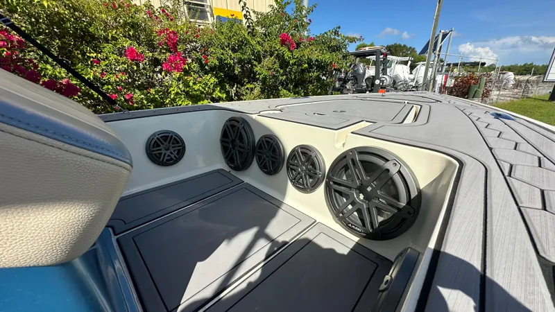 Slide: The Image of 2018 Outlaw 300R boat interior with multiple speakers, surrounded by vibrant greenery. - 11
