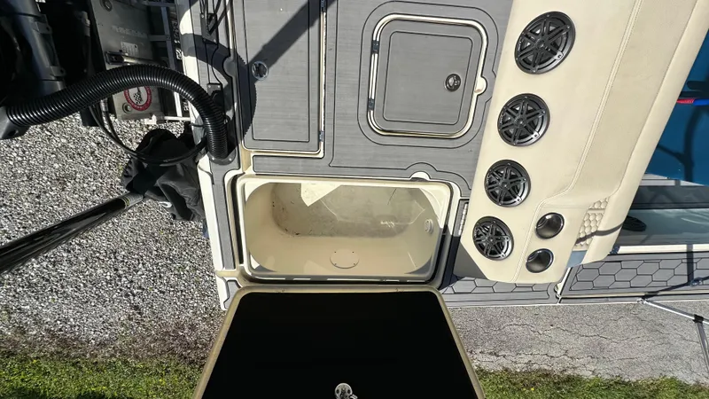 Slide: The Image of 2018 Outlaw 300R boat interior with storage compartments and speaker system. - 9