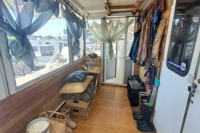 Slide: The Image of 1989 DeFever 57 POC Motor Yacht interior with wooden decor and nautical accessories. - 10