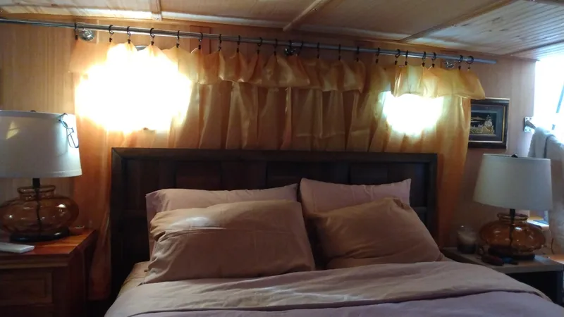 Slide: The Image of Cozy bedroom interior on 1989 DeFever 57 POC Motor Yacht with warm lighting and wooden accents. - 18