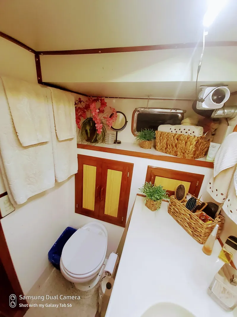 Slide: The Image of Bathroom interior of 1989 DeFever 57 POC Motor Yacht with towels and decorative plants. - 19