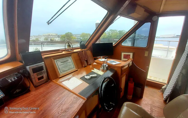 Slide: The Image of 1989 DeFever 57 POC Motor Yacht helm with navigation equipment and waterfront view. - 28