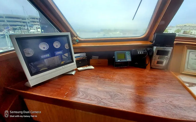 Slide: The Image of 1989 DeFever 57 POC Motor Yacht helm with navigation equipment and wooden dashboard. - 30