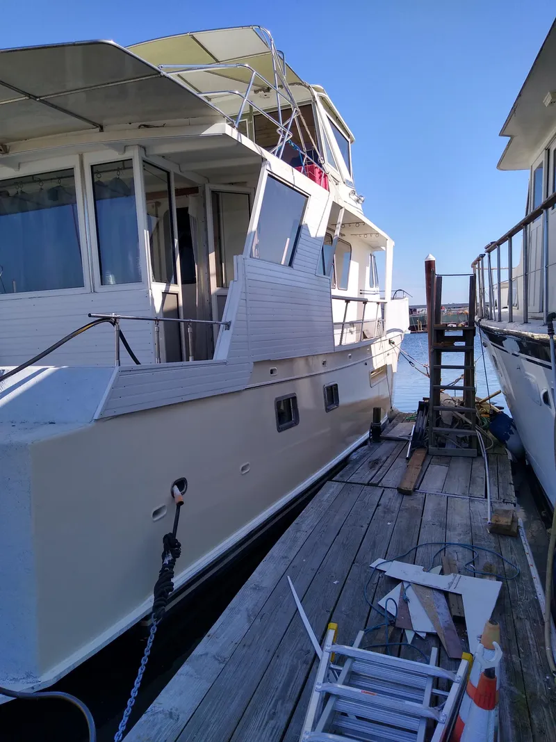 Slide: The Image of 1989 DeFever 57 POC Motor Yacht docked, with visible deck and windows. - 4