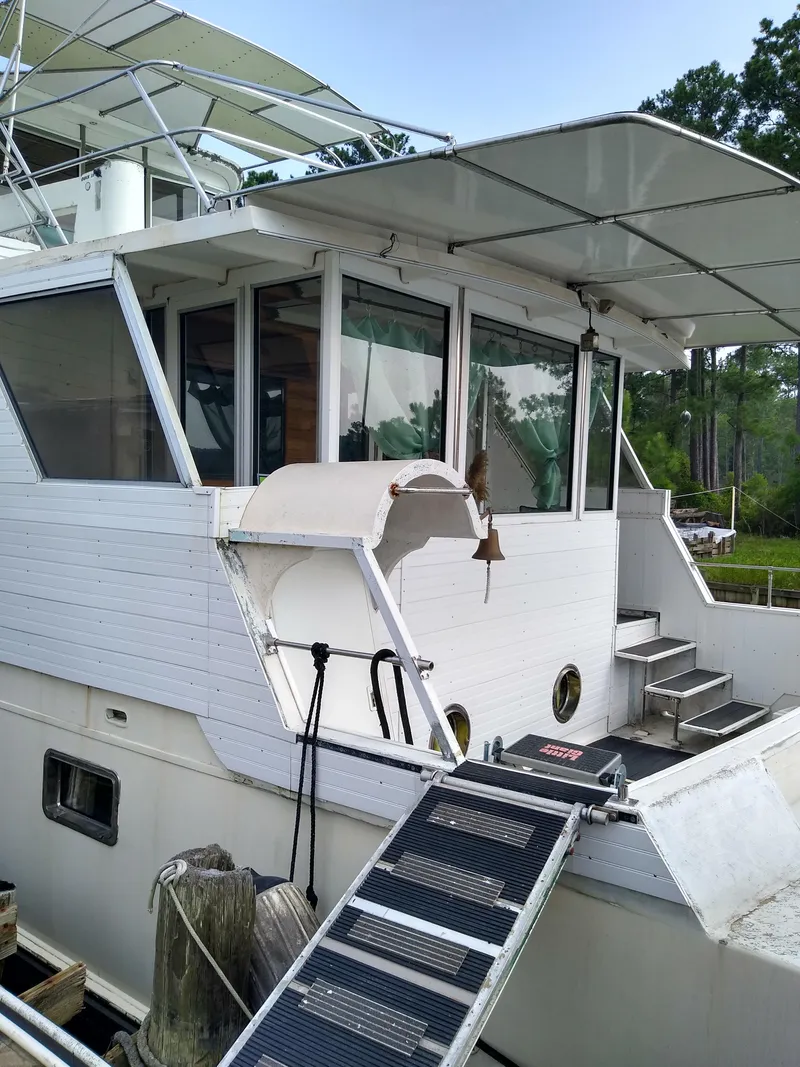 Slide: The Image of 1989 DeFever 57 POC Motor Yacht docked with boarding ramp and visible upper deck. - 7
