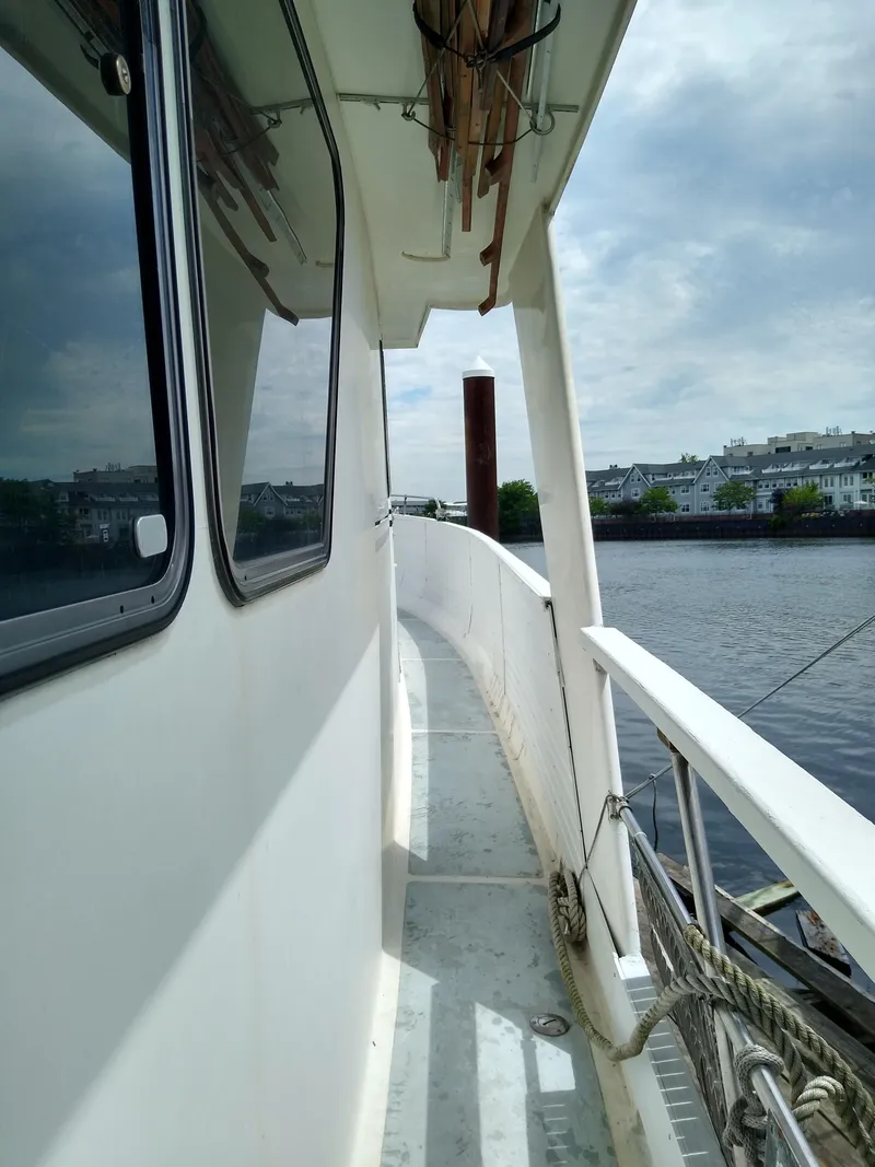 Slide: The Image of Side view of 1989 DeFever 57 POC Motor Yacht on a calm river. - 8