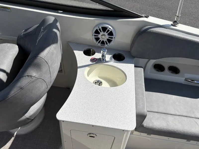 Slide: The Image of 2021 Stingray 231 DC boat interior with seating, sink, and speaker. - 15