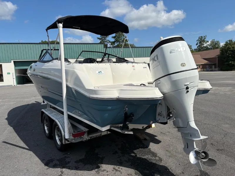 Slide: The Image of 2021 Stingray 231 DC boat on trailer with Suzuki 250 outboard motor. - 6
