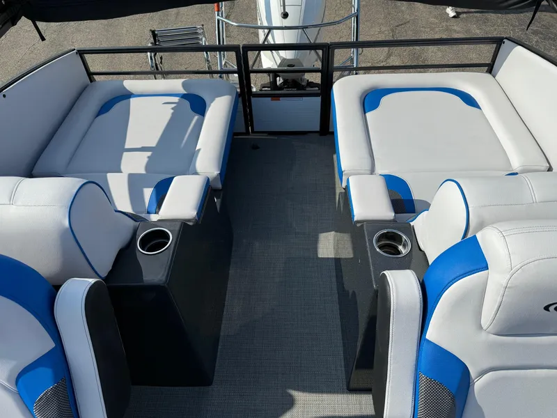 Slide: The Image of 2023 Crest Caribbean RS 230 boat interior with blue and white seating and cup holders. - 10