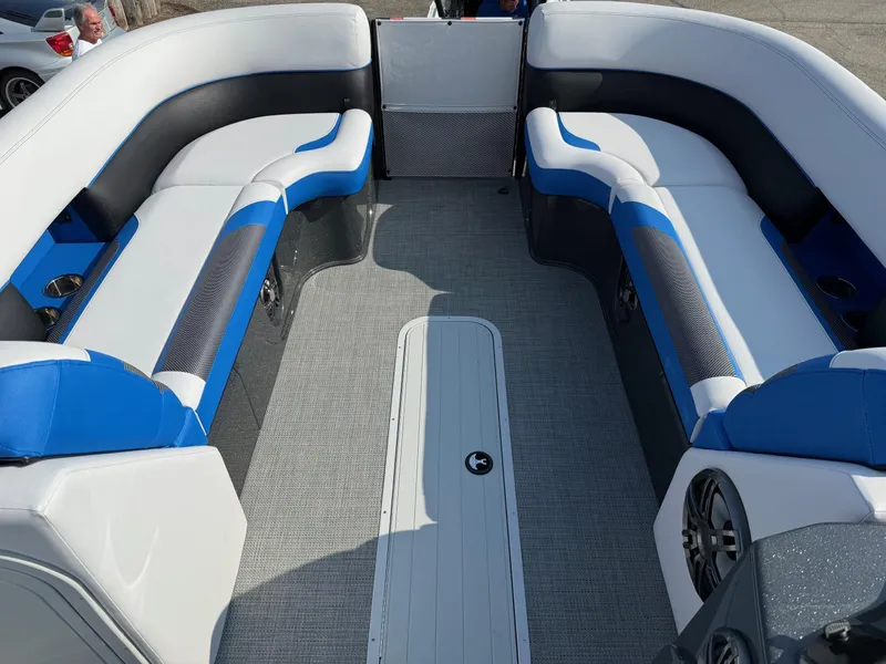 Slide: The Image of 2023 Crest Caribbean RS 230 boat interior with blue and white seating, gray flooring. - 3