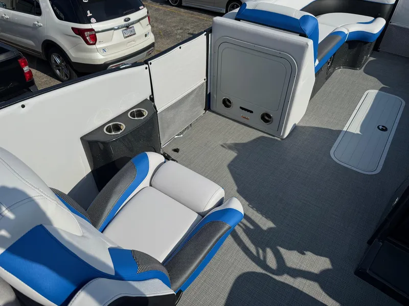 Slide: The Image of 2023 Crest Caribbean RS 230 boat interior with blue and white seating and cup holders. - 8