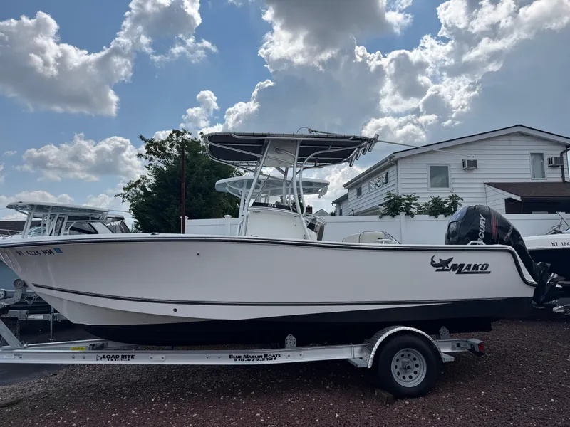 The Image of 2017 Mako 214 CC boat on trailer under cloudy sky. - 0