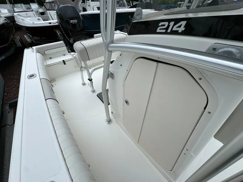 Slide: The Image of 2017 Mako 214 CC boat interior with seating and storage compartments. - 13