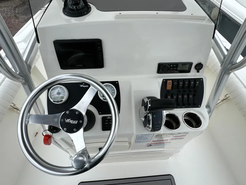 Slide: The Image of 2017 Mako 214 CC boat dashboard with steering wheel and control panel. - 15