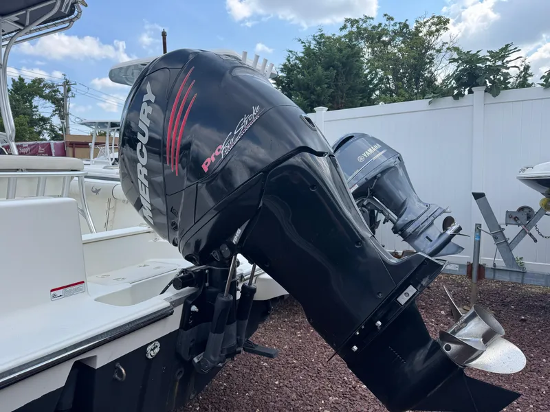 Slide: The Image of 2017 Mako 214 CC boat with Mercury Pro XS outboard motor, parked outdoors. - 2