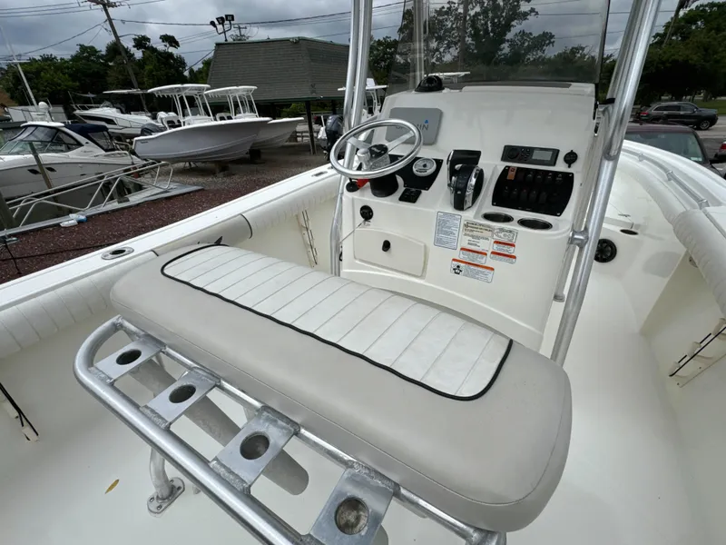 Slide: The Image of 2017 Mako 214 CC boat interior with steering console and seating. - 7