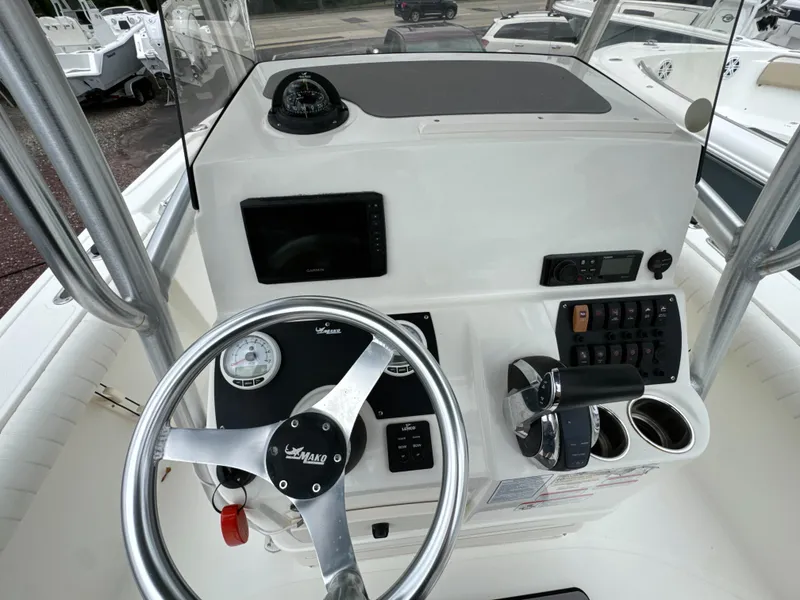 Slide: The Image of 2017 Mako 214 CC boat console with steering wheel, gauges, and controls. - 8