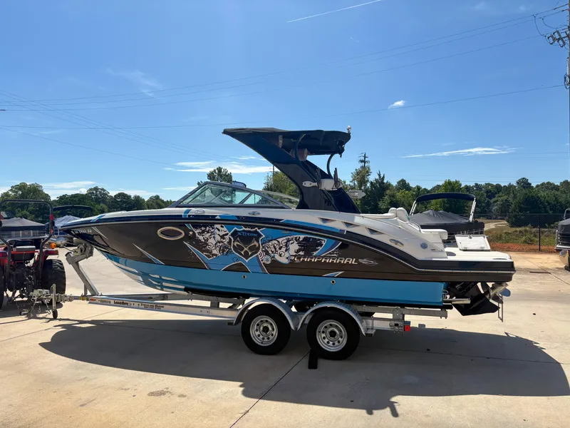 The Image of 2012 Chaparral 244 Xtreme boat on trailer, vibrant graphics, sunny day, outdoor setting. - 1