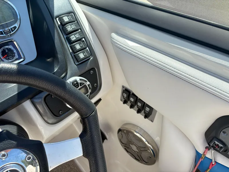 Slide: The Image of Interior dashboard of a 2012 Chaparral 244 Xtreme boat with steering wheel and controls. - 13
