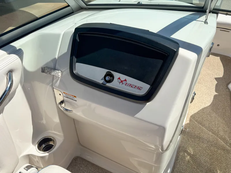 Slide: The Image of 2012 Chaparral 244 Xtreme boat interior with glove compartment and cup holder. - 14