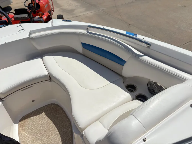 Slide: The Image of 2012 Chaparral 244 Xtreme boat interior with white seating and cup holders. - 18