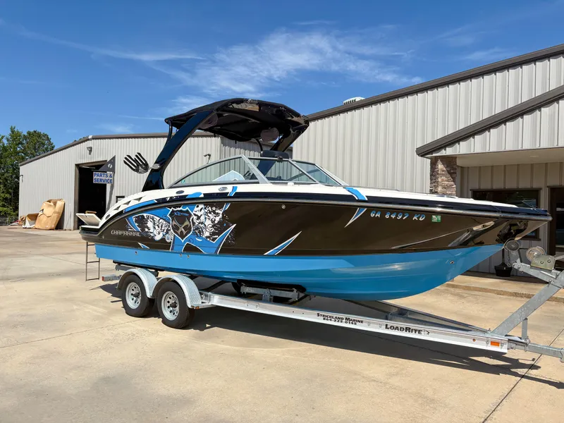 Slide: The Image of 2012 Chaparral 244 Xtreme boat on trailer outside service building. - 4