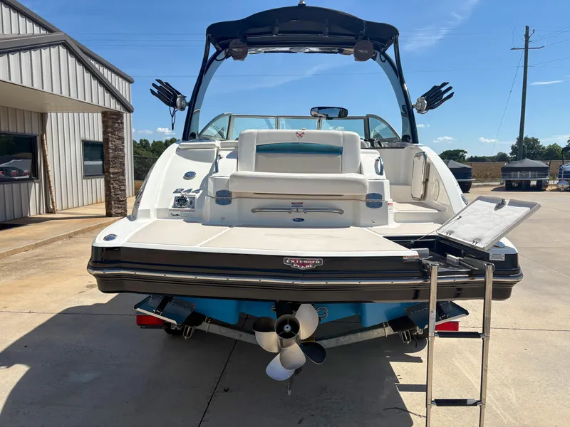Slide: The Image of 2012 Chaparral 244 Xtreme boat with swim platform and ladder, parked outdoors. - 6