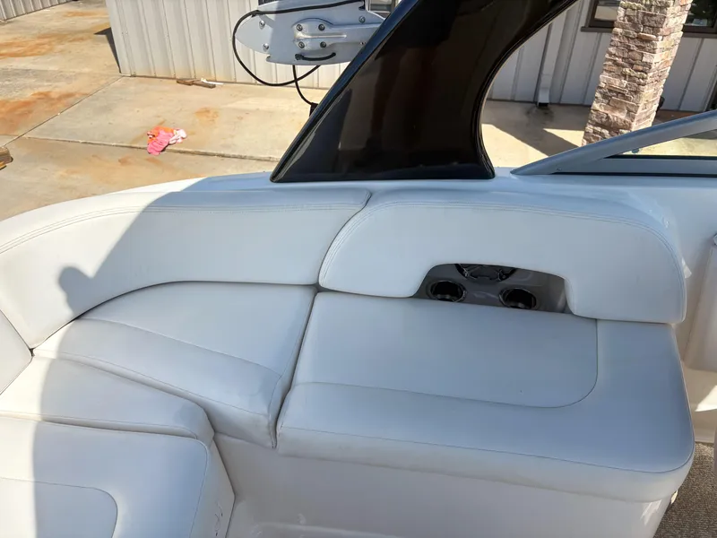 Slide: The Image of 2012 Chaparral 244 Xtreme boat interior with white seating and cup holders. - 8