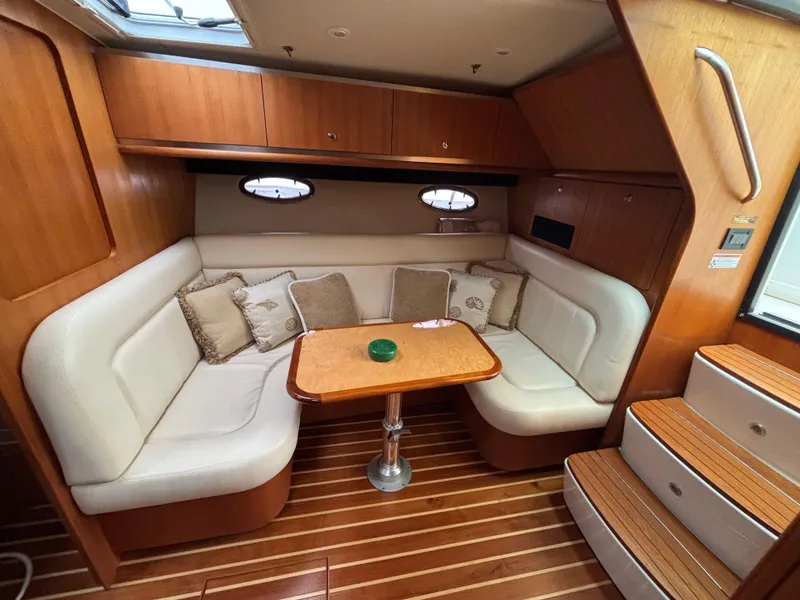 Slide: The Image of 2008 Tiara Yachts 3600 Open interior with cozy seating and wooden accents. - 12