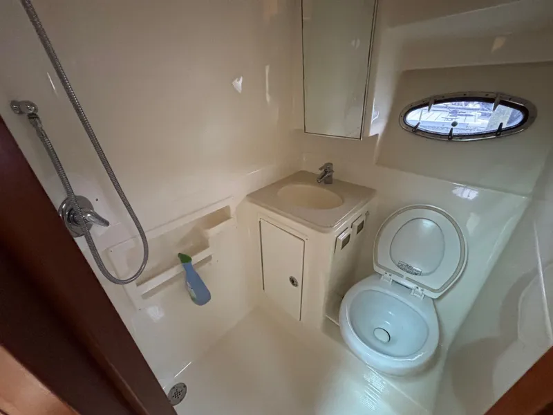 Slide: The Image of Bathroom interior of 2008 Tiara Yachts 3600 Open, featuring shower, sink, and toilet. - 13