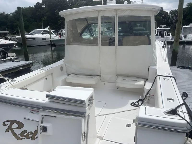 Slide: The Image of 2008 Tiara Yachts 3600 Open docked, featuring spacious deck and seating area. - 5