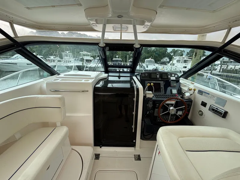 Slide: The Image of 2008 Tiara Yachts 3600 Open cockpit with steering wheel and seating, docked at marina. - 6
