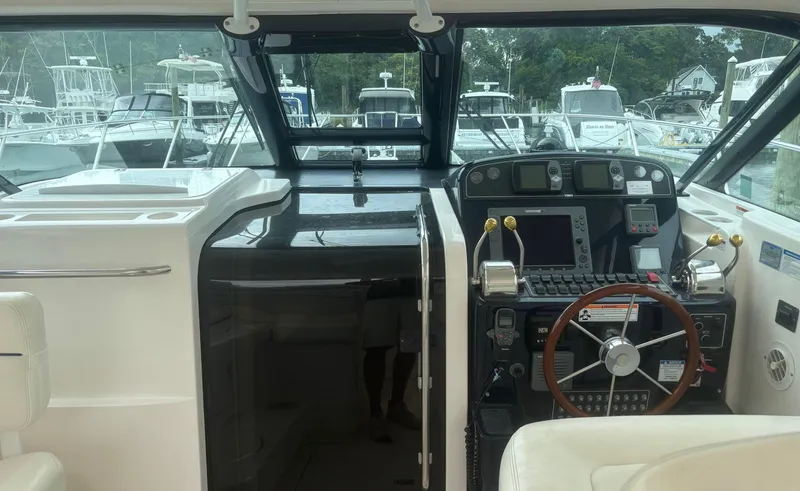 Slide: The Image of 2008 Tiara Yachts 3600 Open helm with modern navigation equipment and luxurious seating. - 9