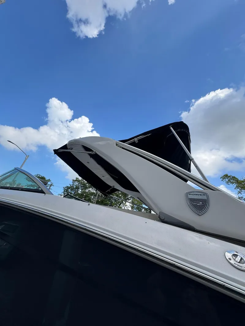 Slide: The Image of 2018 Regal 29 OBX boat against a blue sky with clouds. - 12