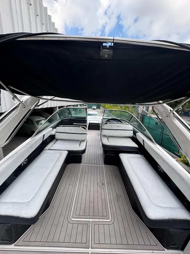 Slide: The Image of 2018 Regal 29 OBX boat interior with spacious seating and canopy. - 13