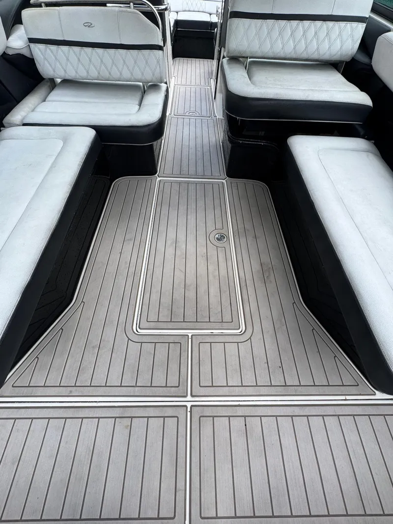 Slide: The Image of 2018 Regal 29 OBX boat interior with cushioned seating and sleek flooring. - 14