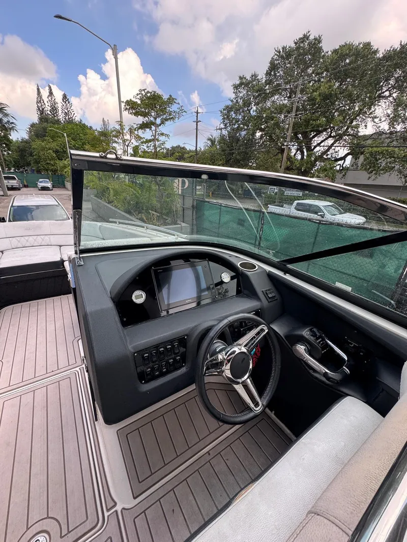 Slide: The Image of 2018 Regal 29 OBX boat cockpit with steering wheel and dashboard controls. - 17