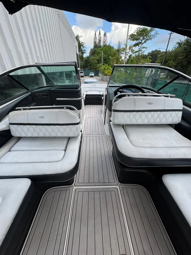 Slide: The Image of 2018 Regal 29 OBX boat interior with white seating and sleek design. - 19