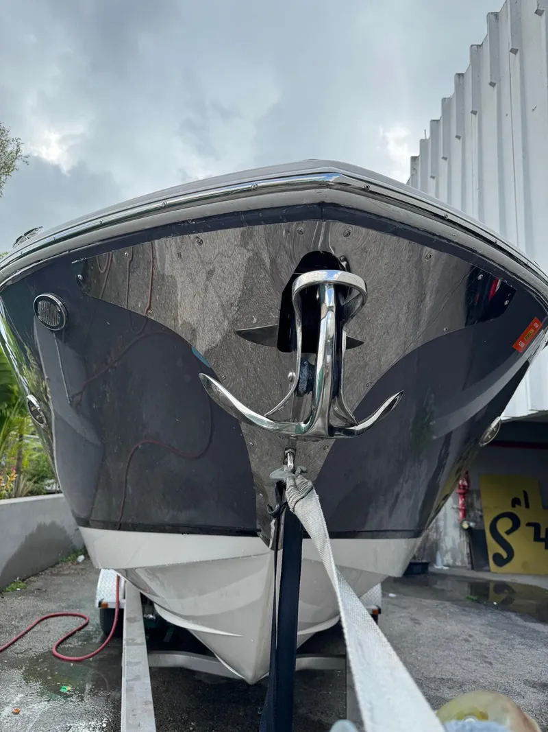 Slide: The Image of 2018 Regal 29 OBX boat on trailer, front view with anchor, overcast sky. - 3