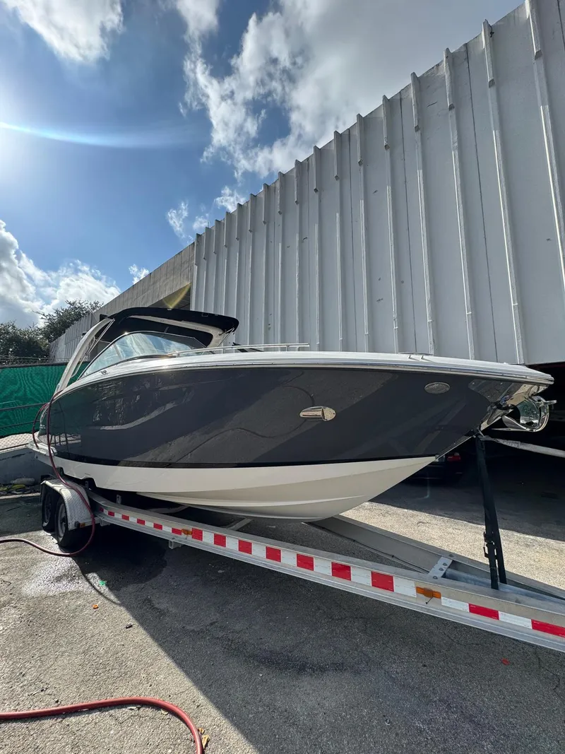 Slide: The Image of 2018 Regal 29 OBX boat on trailer under a sunny sky. - 7