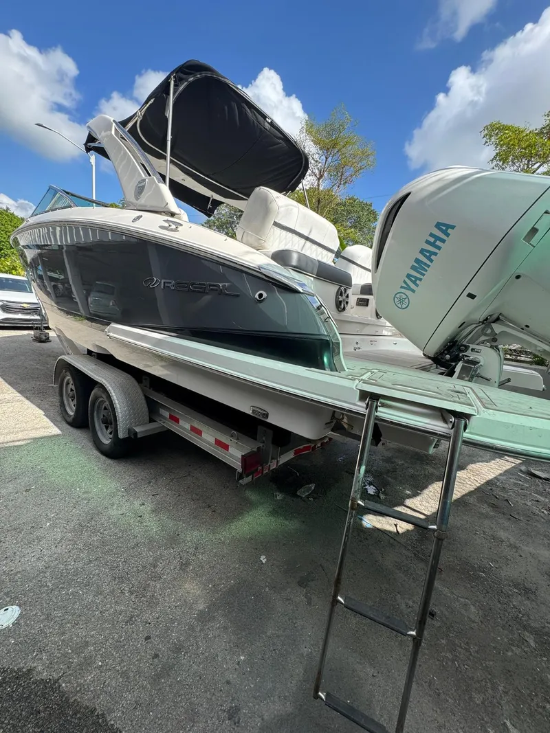 Slide: The Image of 2018 Regal 29 OBX boat on trailer with Yamaha outboard motor under clear blue sky. - 9