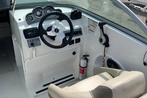 Slide: The Image of 2014 NauticStar 223DC Sport Deck boat interior with steering wheel and dashboard controls. - 10