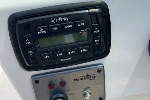 Slide: The Image of Infinity stereo system on 2014 NauticStar 223DC Sport Deck boat dashboard. - 11