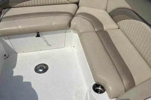 Slide: The Image of 2014 NauticStar 223DC Sport Deck boat interior with beige seating and cup holder. - 16