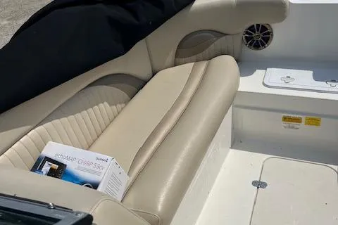 Slide: The Image of 2014 NauticStar 223DC Sport Deck interior with beige seating and marine equipment. - 6