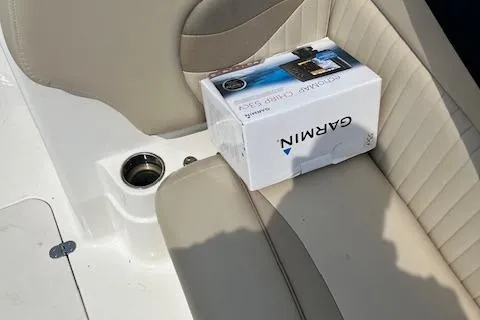 Slide: The Image of Box of Garmin electronics on 2014 NauticStar 223DC Sport Deck boat seat. - 8