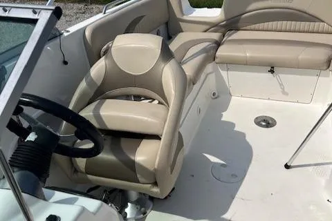 Slide: The Image of 2014 NauticStar 223DC Sport Deck boat interior with beige seating and steering wheel. - 9