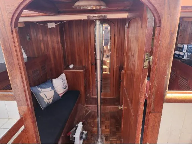 Slide: The Image of 1978 Hardin Voyager 44 interior with wooden finish and nautical-themed cushions. - 11