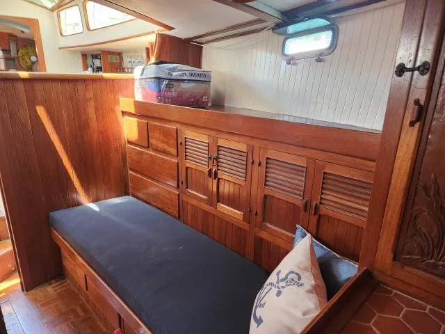 Slide: The Image of Interior of 1978 Hardin Voyager 44 sailboat with wooden cabinetry and cushioned seating. - 14