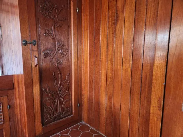 Slide: The Image of Wood-paneled interior of 1978 Hardin Voyager 44 with ornate carved door. - 15